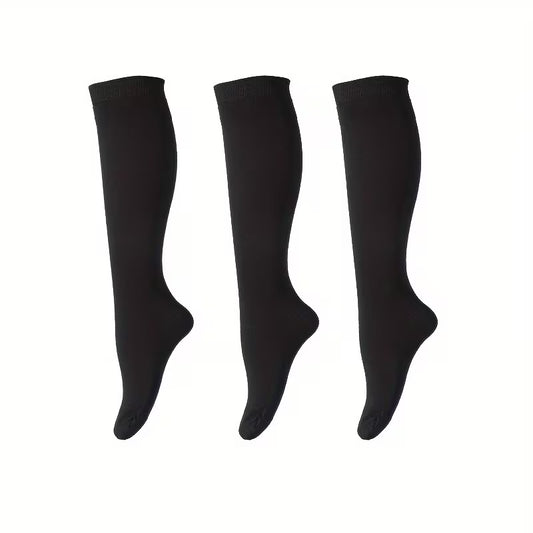 Three black knee-high socks on a white background
